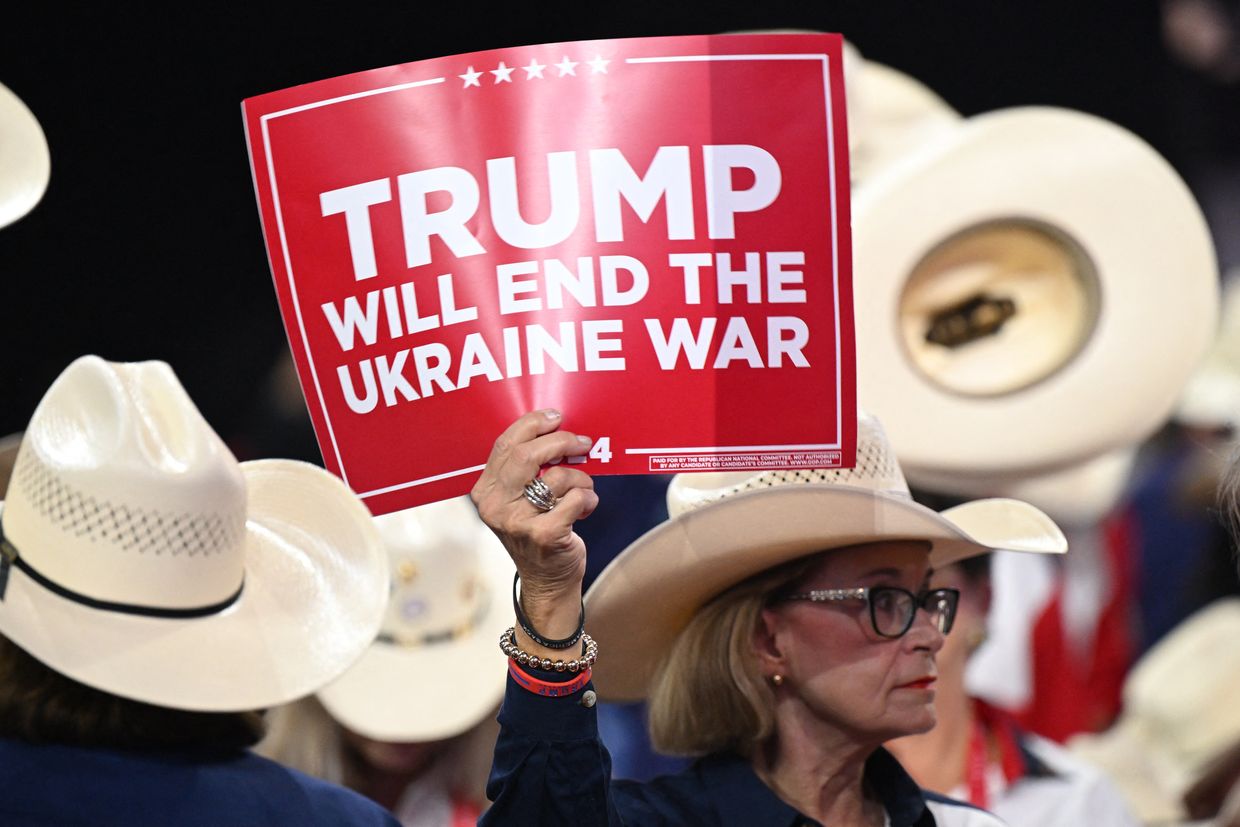 A woman holds a "Trump will end the Ukraine war" sign at the 2024 Republican National Convention in Milwaukee, Wis., July 17.